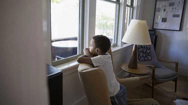 Child looking out a window.
